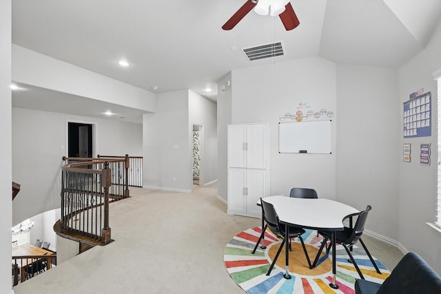 recreation room featuring ceiling fan, visible vents, vaulted ceiling, baseboards, and light carpet