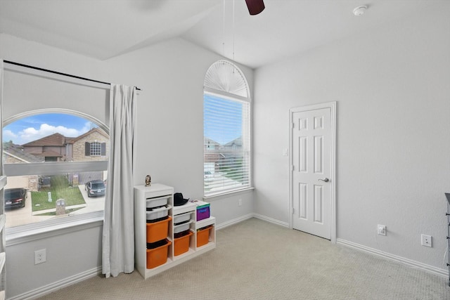 recreation room featuring ceiling fan, vaulted ceiling, baseboards, and carpet