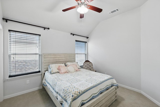 bedroom featuring carpet floors, baseboards, vaulted ceiling, and visible vents