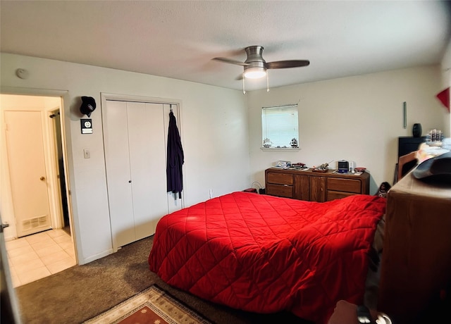 carpeted bedroom featuring a closet and a ceiling fan