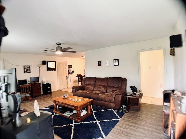 living room featuring a ceiling fan and wood finished floors