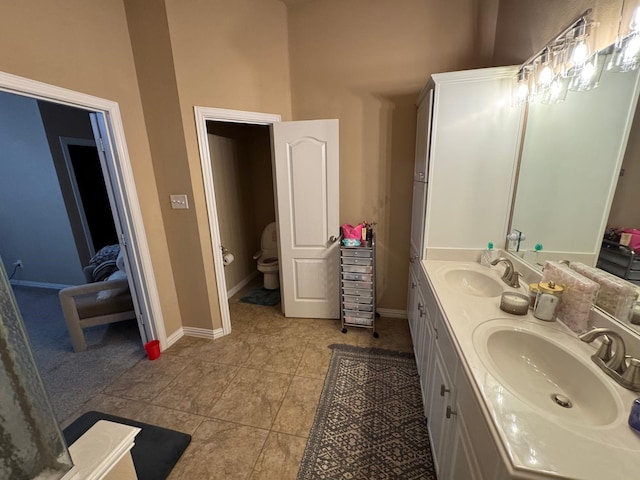 1932 Loma Linda Dr, Irving, TX 75063 - bathroom featuring double vanity, baseboards, a sink, and tile patterned flooring