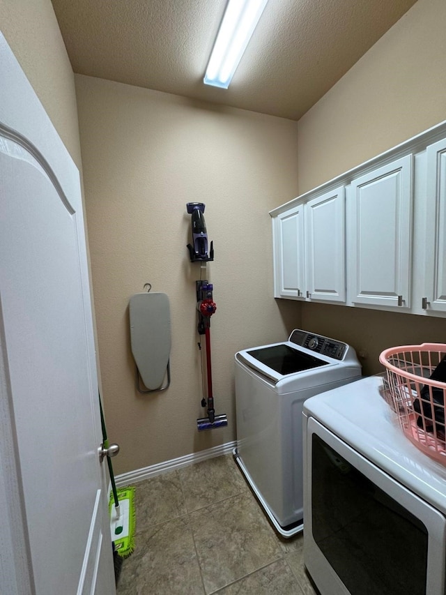 1932 Loma Linda Dr, Irving, TX 75063 - laundry area with light tile patterned floors, baseboards, washing machine and dryer, and cabinet space