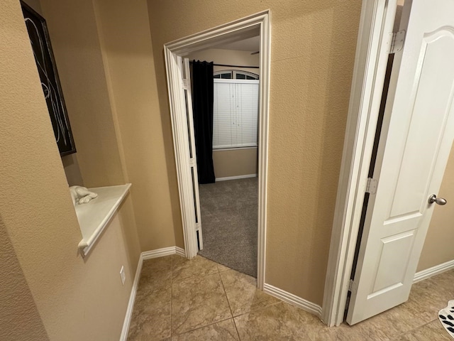 1932 Loma Linda Dr, Irving, TX 75063 - hallway with light tile patterned floors, baseboards, and a textured wall