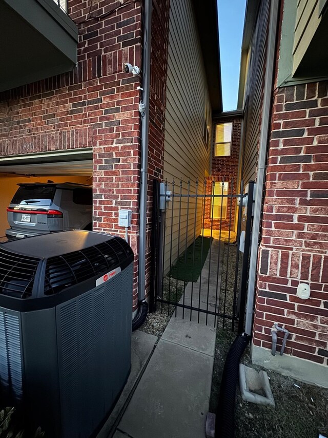1932 Loma Linda Dr, Irving, TX 75063 - exterior space featuring brick siding, a gate, and central AC