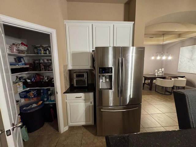 1932 Loma Linda Dr, Irving, TX 75063 - kitchen with dark countertops, stainless steel fridge with ice dispenser, tile patterned flooring, and white cabinetry