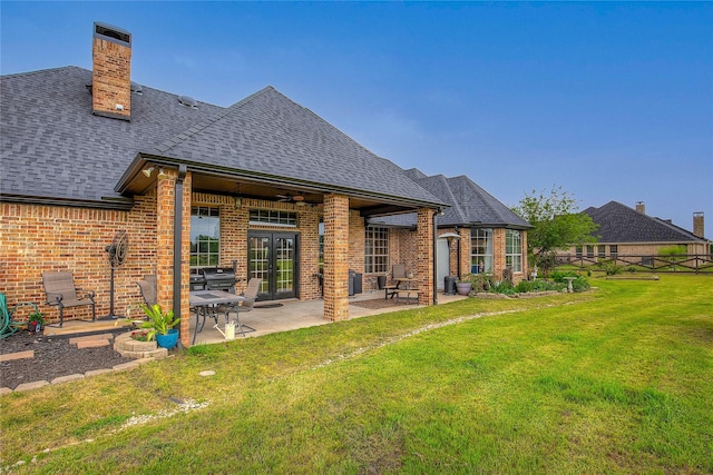 11041 Helms Trl, Forney, TX 75126 - rear view of property featuring french doors, brick siding, a shingled roof, a patio area, and a lawn