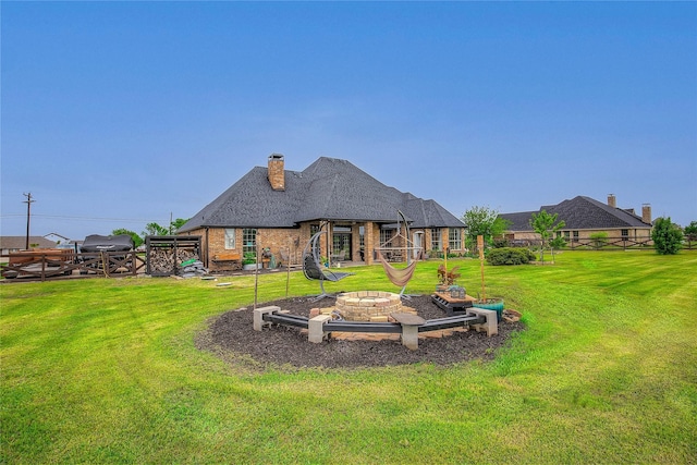 11041 Helms Trl, Forney, TX 75126 - rear view of house with a lawn, fence, a chimney, and an outdoor fire pit