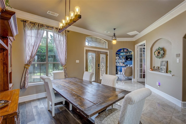 dining room featuring french doors, baseboards, crown molding, and visible vents