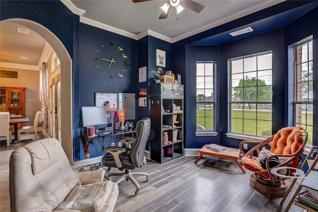 home office with arched walkways, ceiling fan, visible vents, and wood finished floors