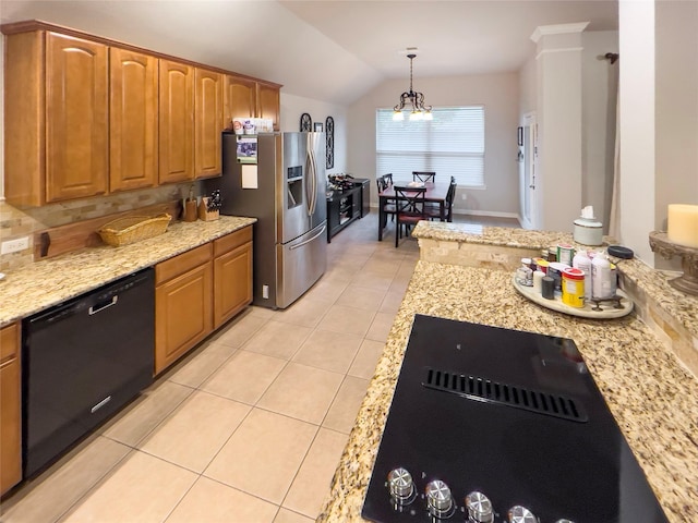 kitchen featuring light tile patterned flooring, a notable chandelier, decorative light fixtures, vaulted ceiling, and black appliances