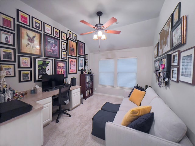 home office featuring ceiling fan, light colored carpet, and lofted ceiling