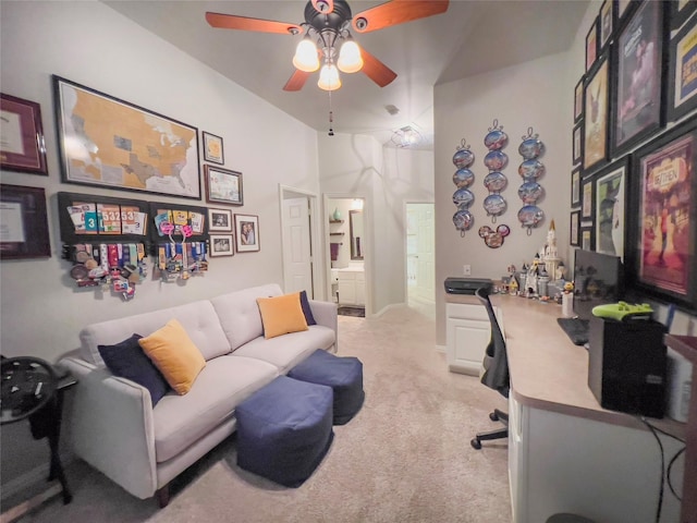 home office with a towering ceiling, ceiling fan, and light carpet