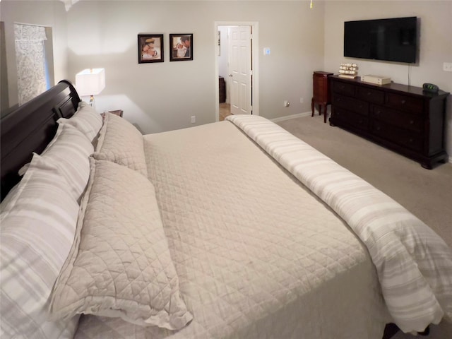 carpeted bedroom featuring baseboards