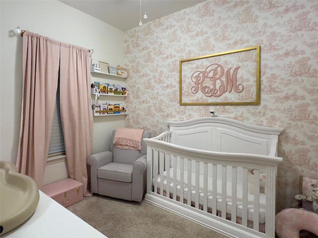 carpeted bedroom with a nursery area and wallpapered walls