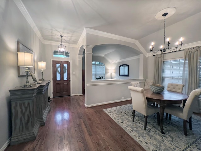 dining room with decorative columns, dark wood-style flooring, arched walkways, baseboards, and an inviting chandelier