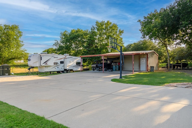 view of parking / parking lot with concrete driveway