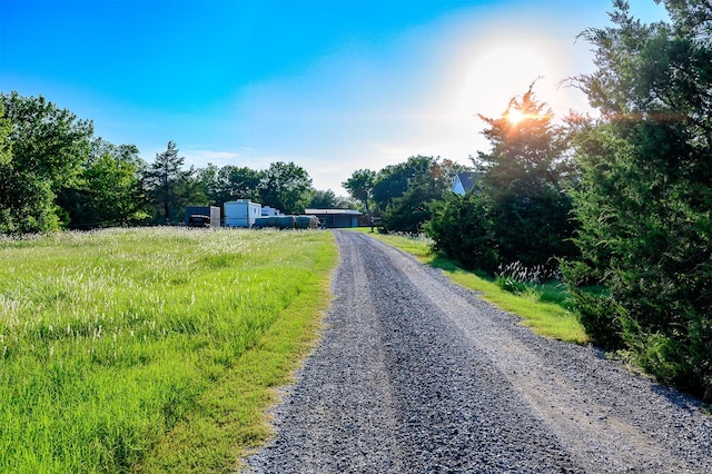 view of street featuring gravel driveway