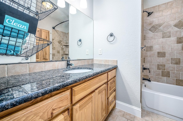 bathroom with baseboards, a textured wall, vanity, and  shower combination
