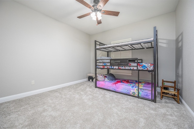 carpeted bedroom featuring a ceiling fan and baseboards