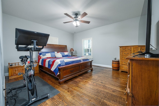 bedroom with dark wood-type flooring, baseboards, and ceiling fan