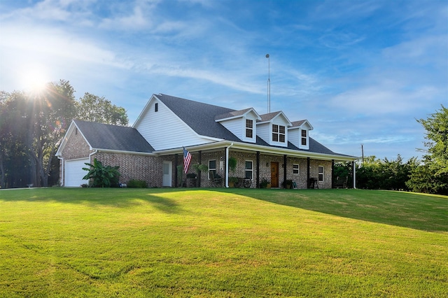 view of front facade featuring a garage, a porch, brick siding, and a front yard