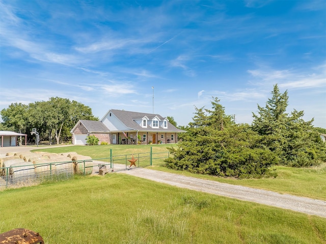 view of yard featuring a garage, fence, a gate, and driveway