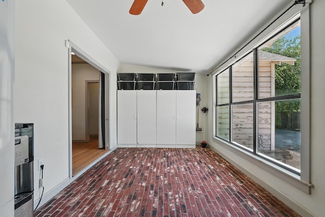 1202 Grand Ave, Abilene, TX 79605 - unfurnished bedroom with brick floors, multiple windows, vaulted ceiling, and a ceiling fan