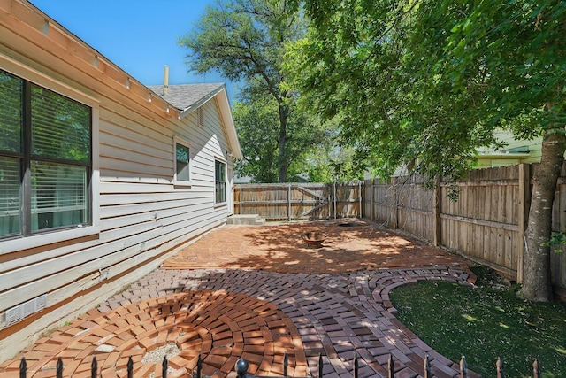 1202 Grand Ave, Abilene, TX 79605 - fenced backyard with a patio area and a fire pit