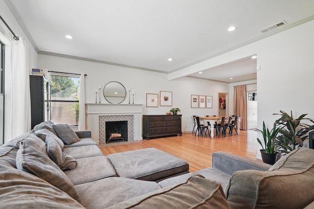 1202 Grand Ave, Abilene, TX 79605 - living room featuring crown molding, light wood-style flooring, recessed lighting, a fireplace, and baseboards