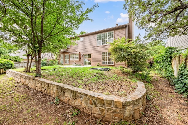 rear view of house featuring a patio and fence