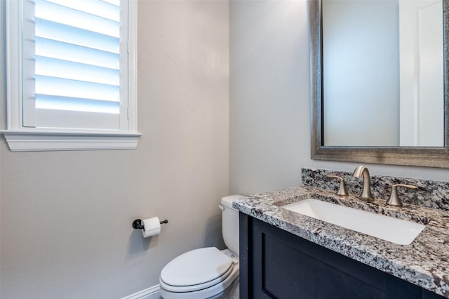 bathroom featuring toilet and vanity
