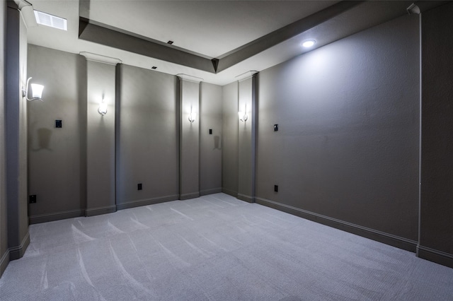 empty room with baseboards, light colored carpet, and visible vents