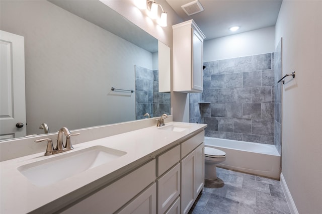 bathroom featuring a sink, toilet, double vanity, and visible vents