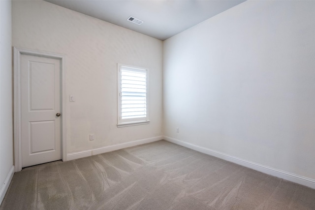 spare room with visible vents, carpet flooring, and baseboards