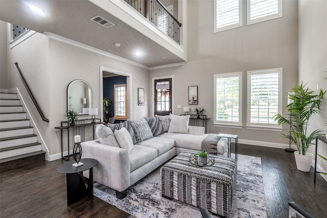 living area with visible vents, baseboards, dark wood-style flooring, and stairway