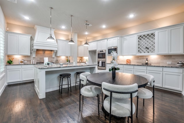 kitchen with visible vents, white cabinetry, and stainless steel appliances