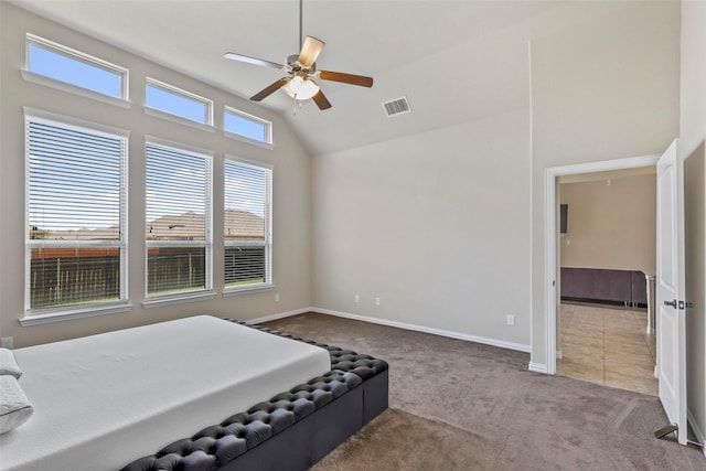 carpeted bedroom featuring a ceiling fan, baseboards, visible vents, and high vaulted ceiling