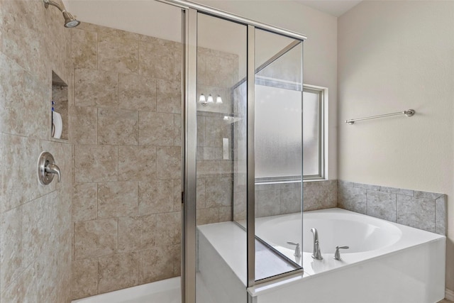 bathroom with a bath and a stall shower