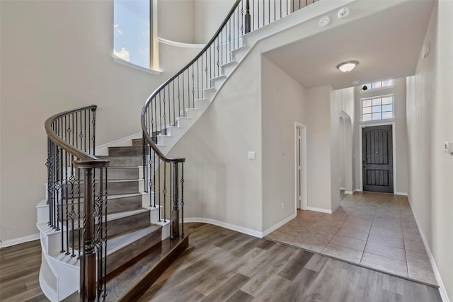 7544 Waterpoint St, Grand Prairie, TX 75054 - foyer entrance featuring a high ceiling, stairway, wood finished floors, and baseboards