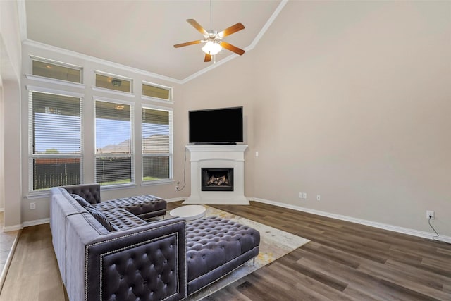 7544 Waterpoint St, Grand Prairie, TX 75054 - living room featuring ceiling fan, baseboards, a fireplace with raised hearth, wood finished floors, and crown molding