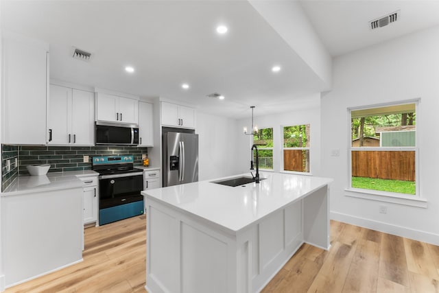 kitchen featuring visible vents, recessed lighting, light countertops, a sink, and stainless steel appliances
