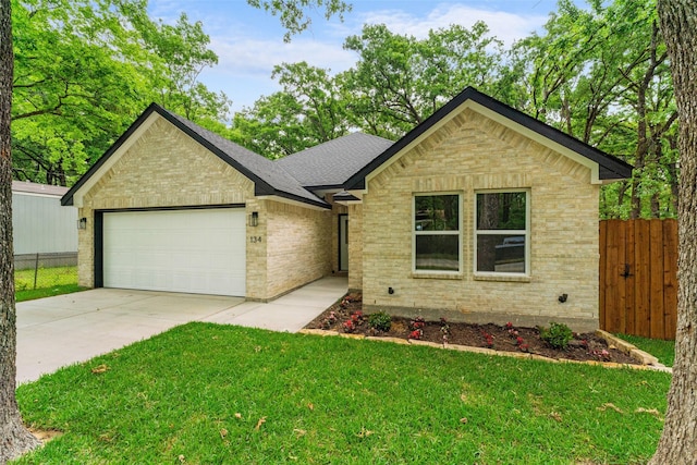 single story home featuring driveway, a front yard, a garage, brick siding, and fence