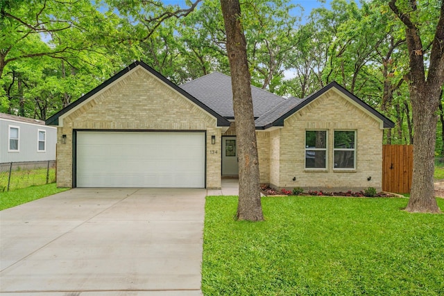 single story home featuring roof with shingles, fence, concrete driveway, and brick siding