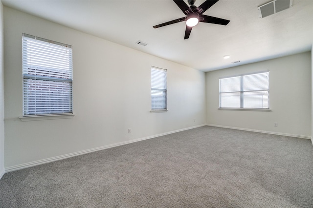 unfurnished room featuring visible vents, baseboards, carpet floors, and ceiling fan