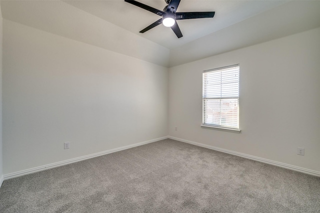 carpeted empty room with ceiling fan, baseboards, and lofted ceiling