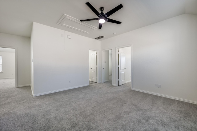 unfurnished bedroom featuring visible vents, attic access, baseboards, and carpet floors