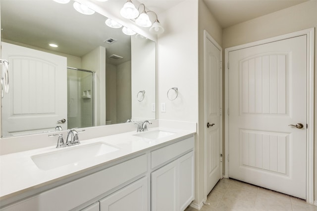 full bath featuring a sink, tile patterned floors, a shower stall, and visible vents