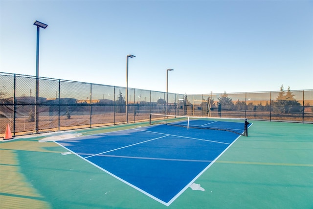 view of tennis court featuring fence
