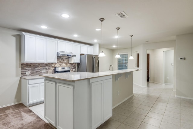 7793 Gulf Walk Rd, Frisco, TX 75036 - kitchen featuring appliances with stainless steel finishes, backsplash, under cabinet range hood, light countertops, and white cabinetry
